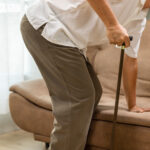 Caregiver takecare older man that having Sarcopenia or muscle loss. Sarcopenia is a degenerative disease of the muscle usually caused by the natural consequence of aging.