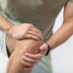 The man grabbed his knee due to severe pain